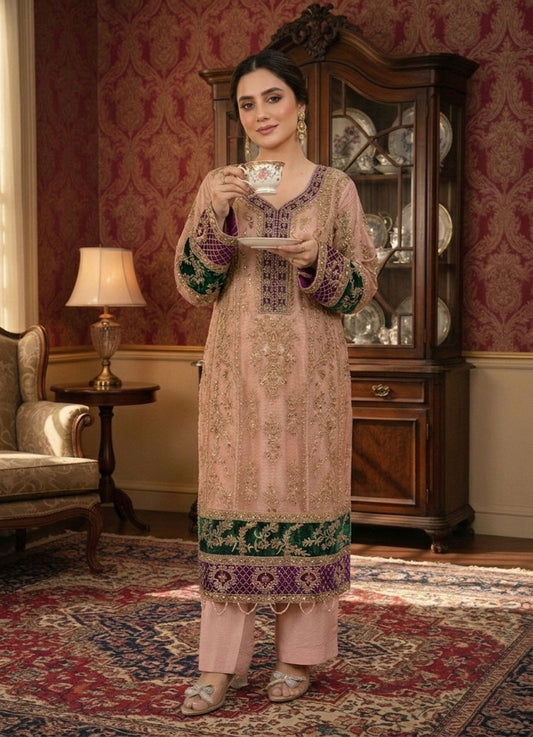 Woman in elegant embroidered Pakistani formal wear suit, festive wear Pakistan, holding teacup