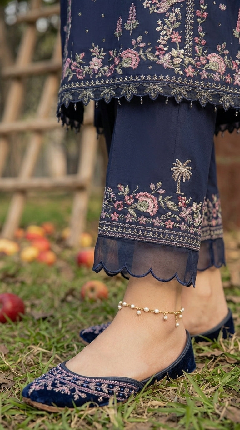 Navy blue embroidered outfit with matching shoes on a grassy background