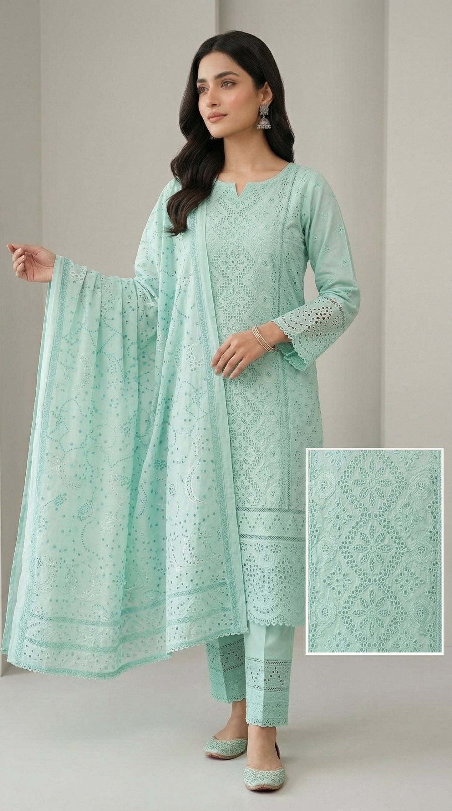 Woman wearing a light green traditional outfit with a matching dupatta on a plain background
