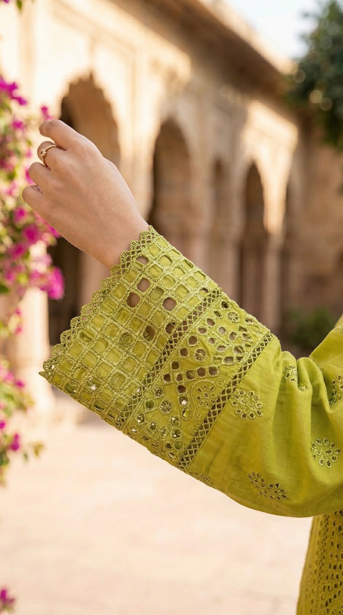 Close-up of a green embroidered sleeve with a blurred background