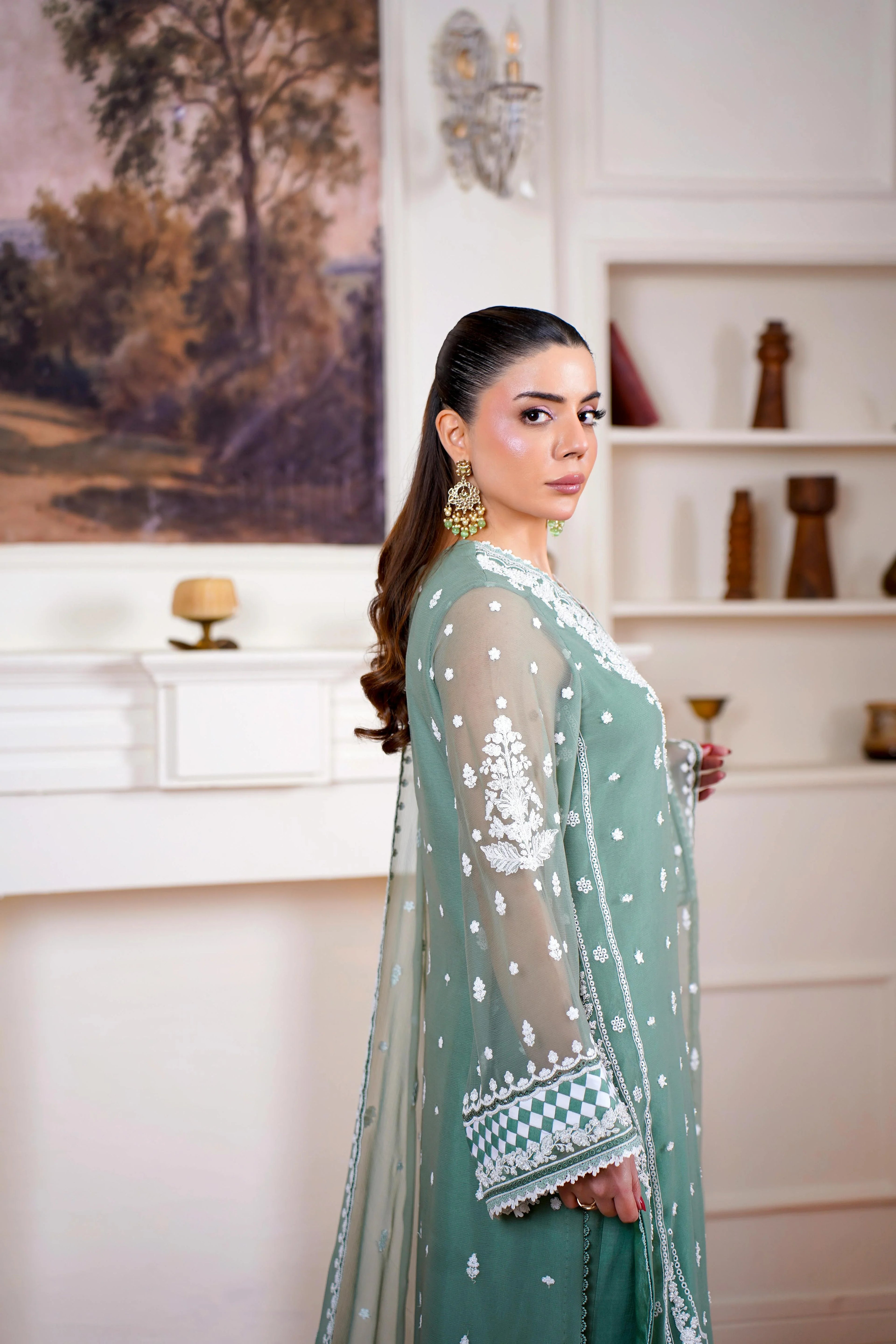 Woman in green embroidered Pakistani dress, festive wear Pakistan, designer suit Pakistan